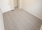 Thumbnail 17 of 23 - A room with a carpeted floor and a white door.