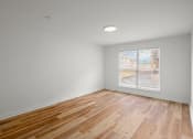 Thumbnail 25 of 31 - an empty room with wood floors and a window at The Courts Midtown, Memphis, 38104