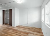 Thumbnail 14 of 31 - an empty room with wood floors and white walls and a glass closet at The Courts Midtown, Memphis, TN, 38104
