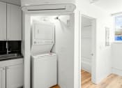 Thumbnail 18 of 31 - a kitchen with a washer and dryer and a white refrigerator at The Courts Midtown, Memphis, Tennessee