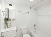 Thumbnail 23 of 31 - a white bathroom with a white toilet and a tub and a sink at The Courts Midtown, Memphis, TN, 38104