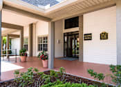 Thumbnail 20 of 26 - The front of a building with a leasing office sign on it.