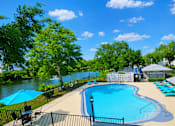Thumbnail 9 of 26 - A pool surrounded by trees and a fence.