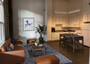 Thumbnail 8 of 9 - a view of a living room with a kitchen in the background at Lofts at Union Alley, Memphis