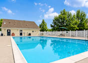 Thumbnail 2 of 17 - A small pool in a backyard with a white fence.