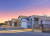 Thumbnail 3 of 3 - a row of houses on a street at sunset