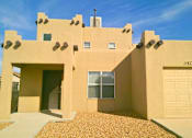 Thumbnail 1 of 3 - the front of a desert house with two garage doors