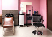 Thumbnail 6 of 6 - A room with a pink wall and a brown chair.
