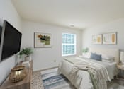 Thumbnail 8 of 19 - A bedroom with a bed, a nightstand, a lamp, a plant, and a painting on the wall.