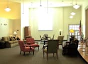 Thumbnail 4 of 4 - A living room with a sofa, chairs, and a coffee table.