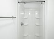 Thumbnail 37 of 40 - White bathroom with shower at Mammoth at the Orchard Apartments, Arkansas
