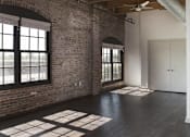 Thumbnail 15 of 16 - A room with a brick wall and a ceiling fan.at South Main Artspace Lofts, Memphis, TN
