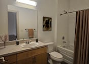 Thumbnail 11 of 16 - A bathroom with a white sink, toilet, and bathtub.at South Main Artspace Lofts, Memphis, TN