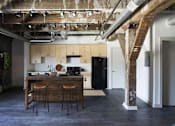 Thumbnail 13 of 16 - A kitchen with a bar stool in front of it.at South Main Artspace Lofts, Memphis, 38126