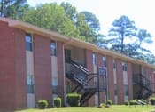 Thumbnail 3 of 4 - a large brick building with a staircase in front of it