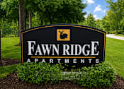 Thumbnail 4 of 5 - A sign for Fawn Ridge Apartments is shown in front of a green lawn.