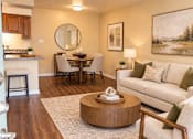 Thumbnail 31 of 33 - A modern living room with a wooden floor and furniture.