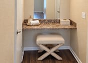 Thumbnail 27 of 33 - A bathroom with a vanity and a mirror.