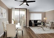 Thumbnail 1 of 28 - A living room with a dining table and chairs.
