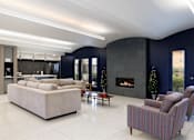 Thumbnail 22 of 28 - A modern living room with a fireplace and a large couch.
