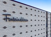 Thumbnail 28 of 28 - The brick wall has a sign that says "Fortune Plaza".