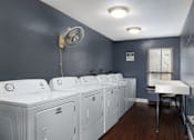 Thumbnail 26 of 28 - A laundry room with washers and dryers.