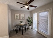 Thumbnail 17 of 21 - A dining room with a table, chairs, and a ceiling fan.