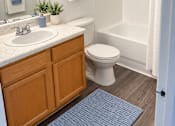Thumbnail 15 of 15 - A bathroom with a toilet, sink, and shower.