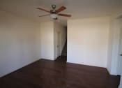 Thumbnail 13 of 13 - an empty living room with a ceiling fan