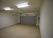 Thumbnail 10 of 13 - an empty garage with a white wall and a garage door