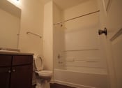 Thumbnail 12 of 13 - a bathroom with a toilet and a shower and a sink
