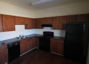Thumbnail 9 of 13 - a kitchen with black appliances and wooden cabinets