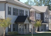 Thumbnail 1 of 13 - a row of houses with trees in front of them