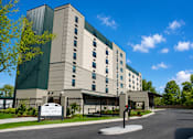 Thumbnail 1 of 7 - A large building with a sign that says "CALVES" in front of it.