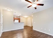 Thumbnail 9 of 12 - A room with a ceiling fan and wooden flooring.