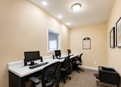 Thumbnail 4 of 12 - A room with a desk and chairs with a window.