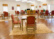 Thumbnail 7 of 19 - A room with red chairs and wooden floors.