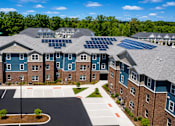 Thumbnail 1 of 7 - A large building with solar panels on the roof.