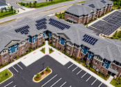 Thumbnail 4 of 7 - A large building with solar panels on the roof.