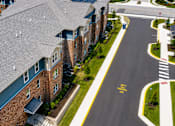 Thumbnail 5 of 7 - A street view of a residential area with apartment buildings.