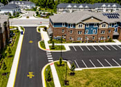 Thumbnail 6 of 7 - A road with a yellow sign that says "STOP HERE ON RED" in front of apartment buildings.