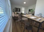 Thumbnail 11 of 31 - a dining room and living room with a table and chairs  at The Courts Midtown, Memphis