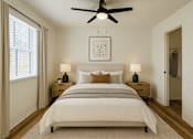 Thumbnail 4 of 40 - A bedroom with a large bed and a ceiling fan.