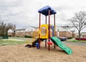 Thumbnail 2 of 17 - a playground with a blue and yellow swing set and a green slide