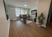 Thumbnail 6 of 31 - a living room with hardwood floors and a couch at The Courts Midtown, Memphis, Tennessee