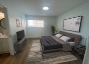 Thumbnail 4 of 31 - a bedroom with a bed and a tv at The Courts Midtown, Memphis, TN, 38104