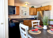Thumbnail 30 of 33 - a kitchen and dining room with a table and chairs
