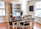 Thumbnail 25 of 33 - a dining room with a table and chairs and a hutch