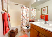 Thumbnail 23 of 33 - a bathroom with a toilet and a sink and a shower