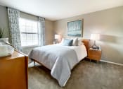 Thumbnail 20 of 33 - a bedroom with a bed and two nightstands and a window